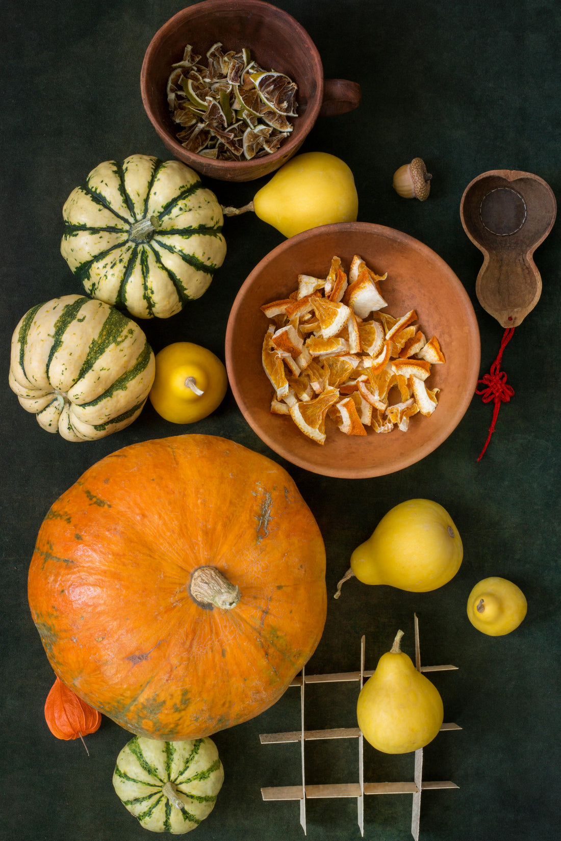 Autumn pumpkins and seasonal fruits on a dark table symbolizing balance and mindfulness during the holiday season